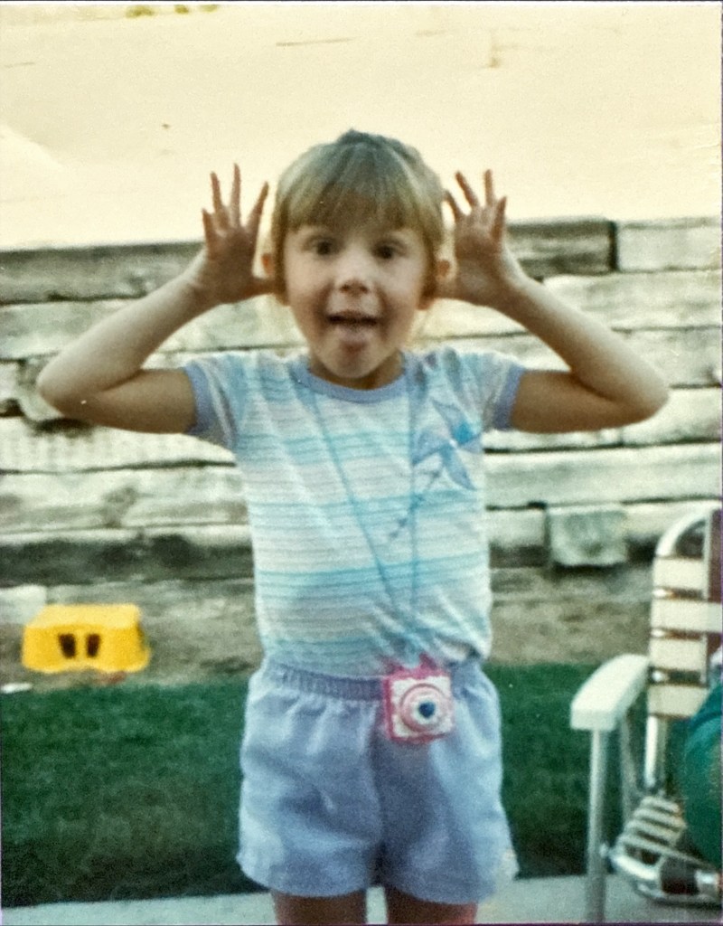 Jana circa 1986 making funny faces wearing summer clothes outside in her home backyard 